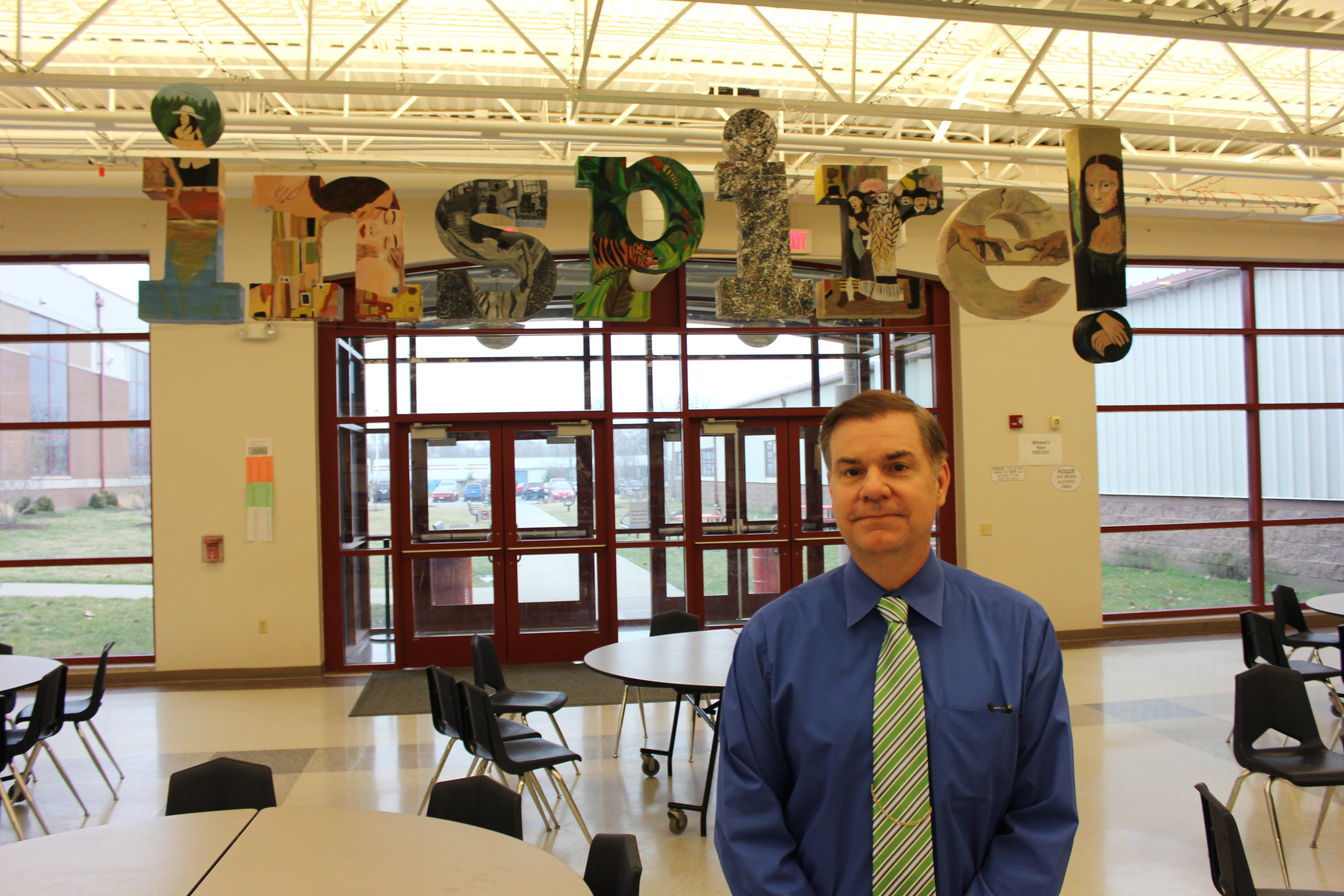Principal Scott Riddle stands in front of an “inspirational” art installation created by the students at Beardstown Junior/High.